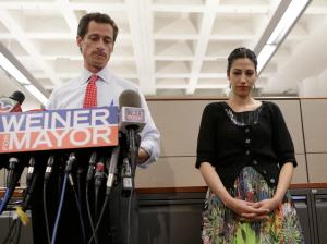 New York mayoral candidate Anthony Weiner speaks during a news conference alongside his wife Huma Abedin at the Gay Men's Health Crisis headquarters, Tuesday, July 23, 2013, in New York.  The former congressman says he's not dropping out of the New York City mayoral race in light of newly revealed explicit online correspondence with a young woman. (AP Photo/Kathy Willens)